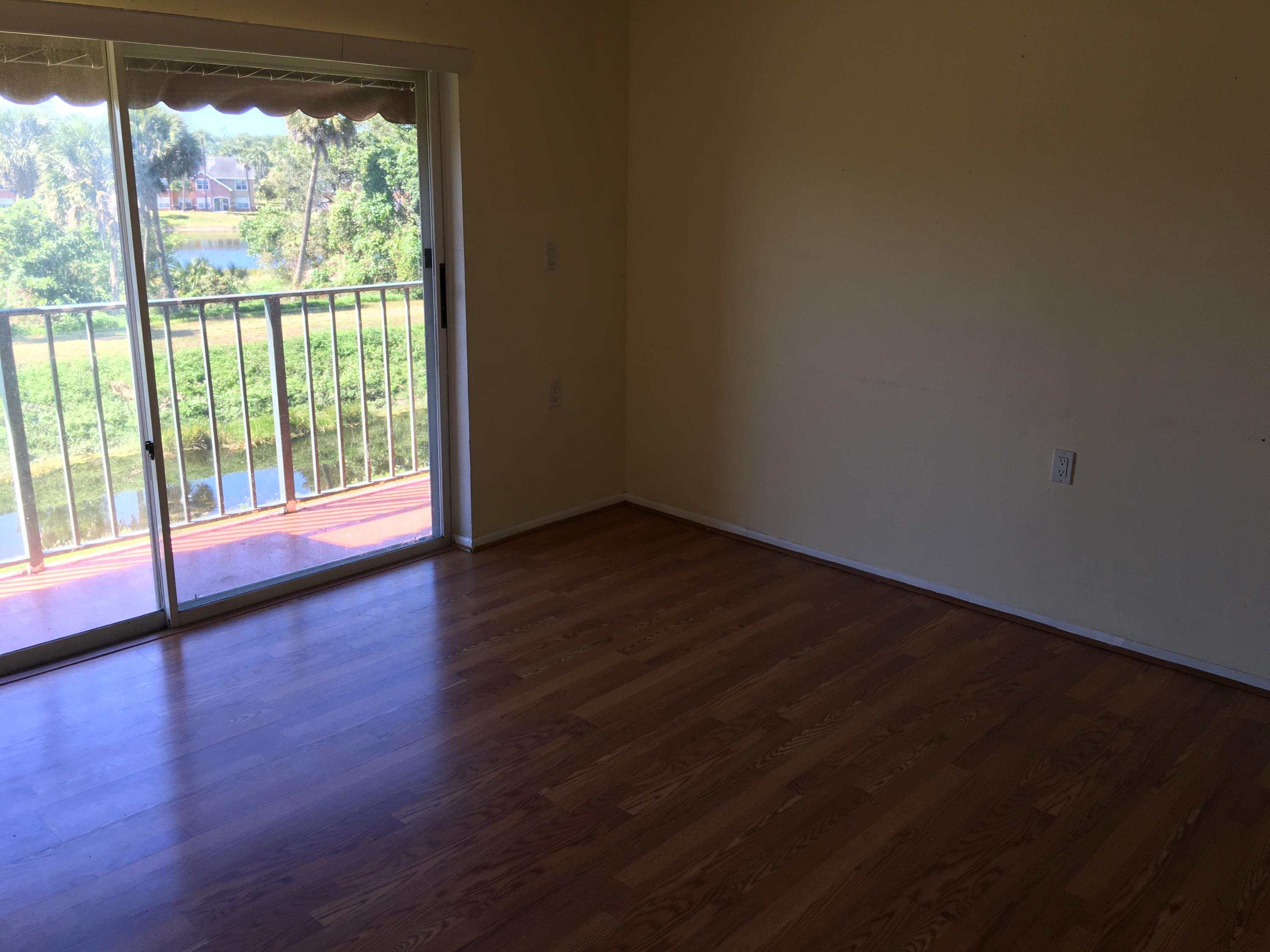 1089 Benoist Farms Road, Unit 306 Royal Palm Beach, FL 33411 - Photo 4 of 9 Great Room with Sliders