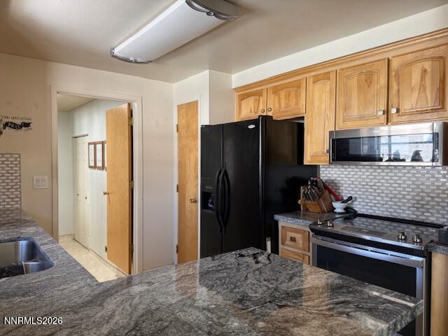 920 Ruby Court Carson City, NV 89705 - Photo 5 of 20 a kitchen with stainless steel appliances granite countertop a refrigerator and a stove top oven