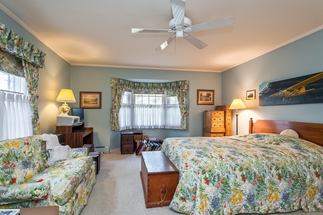 2089 Winnetka Road Northfield, IL 60093 - Photo 8 of 15 a bedroom with a large bed and a chandelier