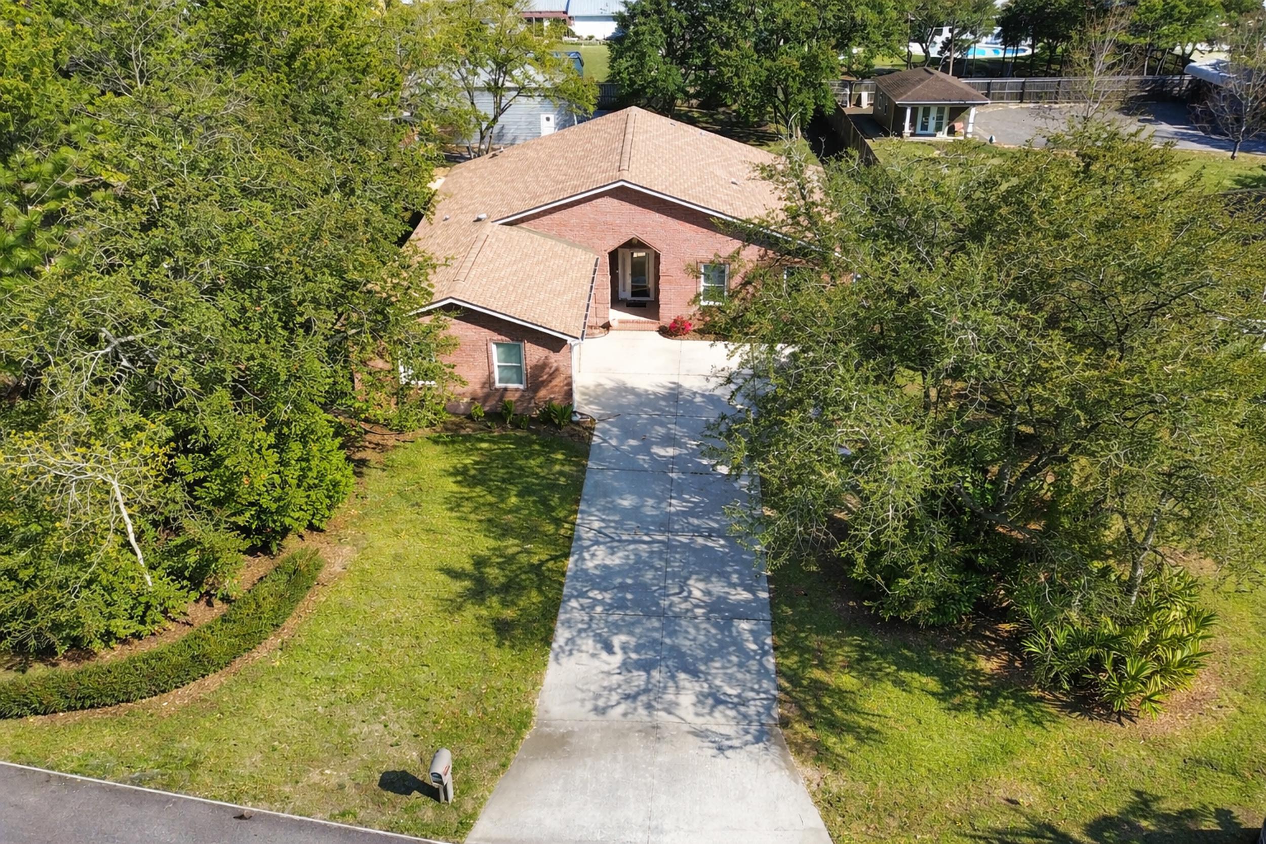 8600 Estrada Street Navarre, FL 32566 - Photo 1 of 63 a aerial view of a house with a yard