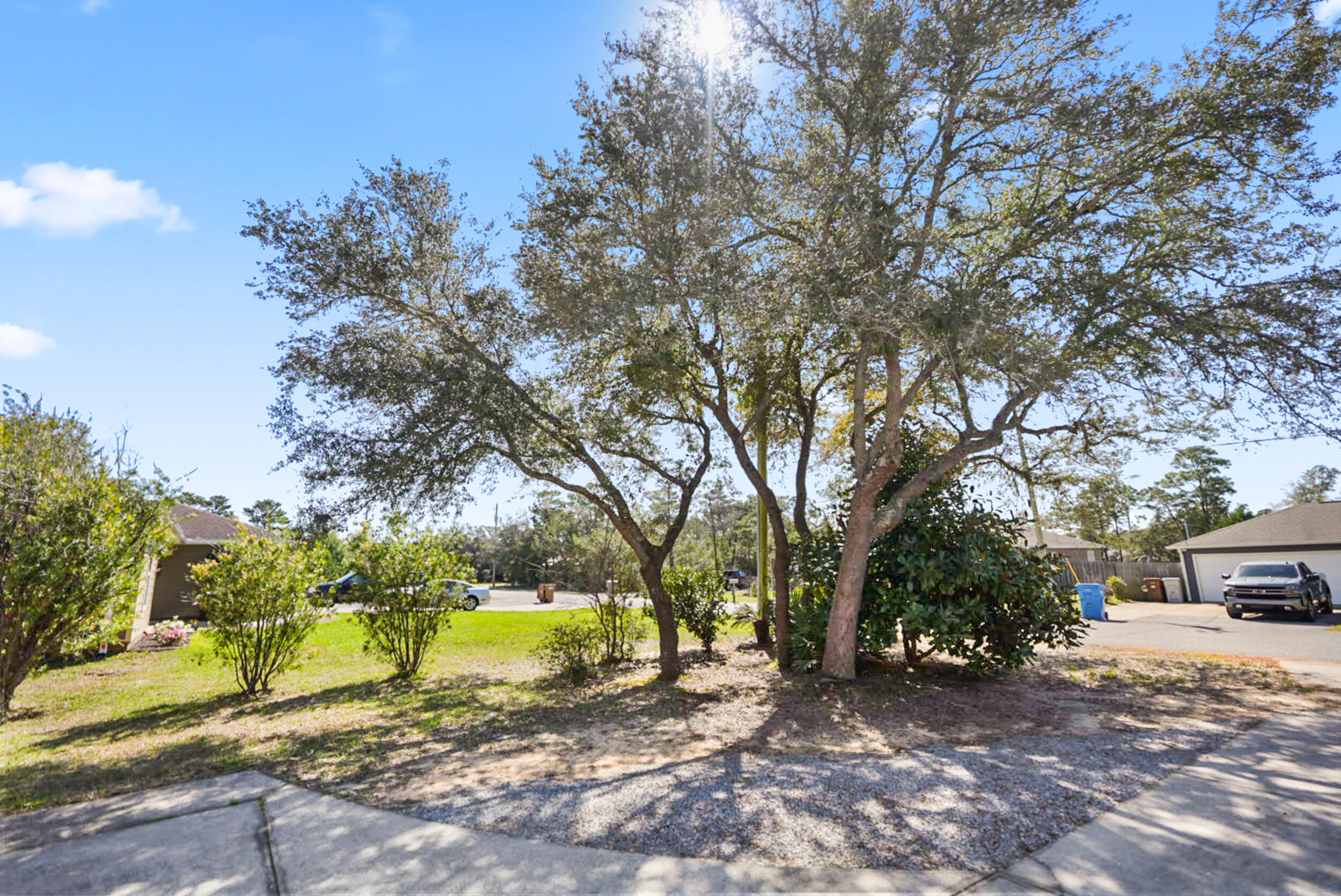8600 Estrada Street Navarre, FL 32566 - Photo 12 of 63 a view of street with large trees