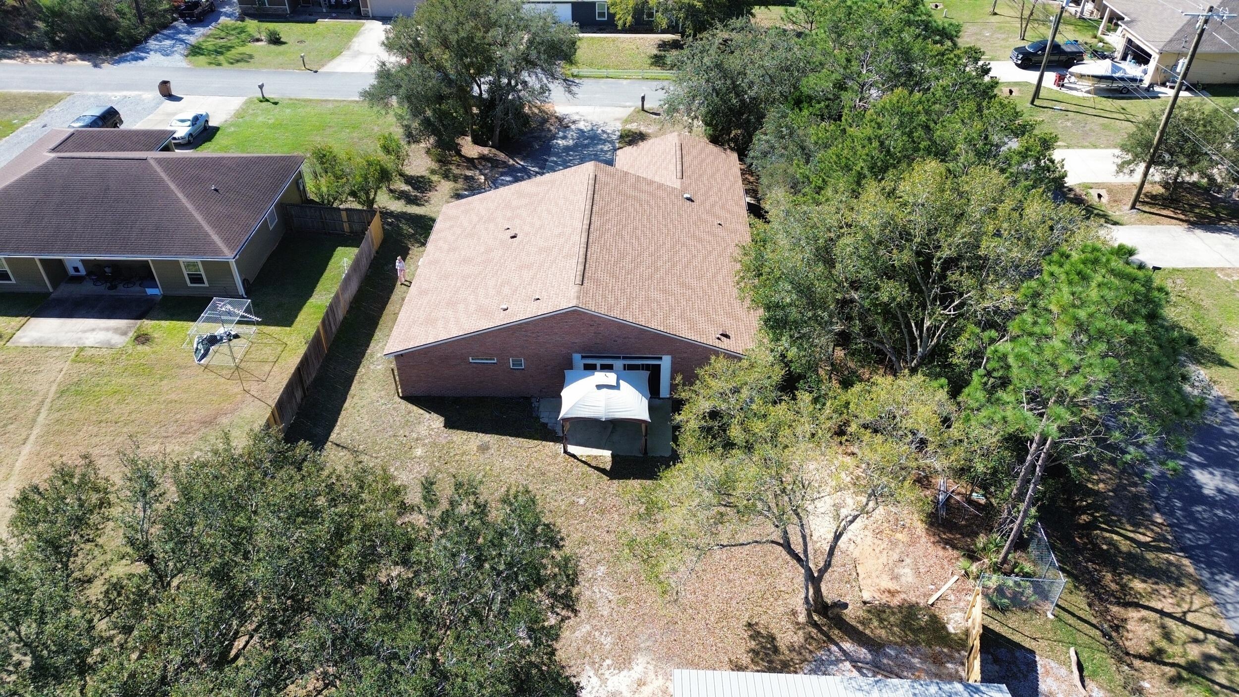 8600 Estrada Street Navarre, FL 32566 - Photo 15 of 63 an aerial view of a house with a yard basket ball court and outdoor seating