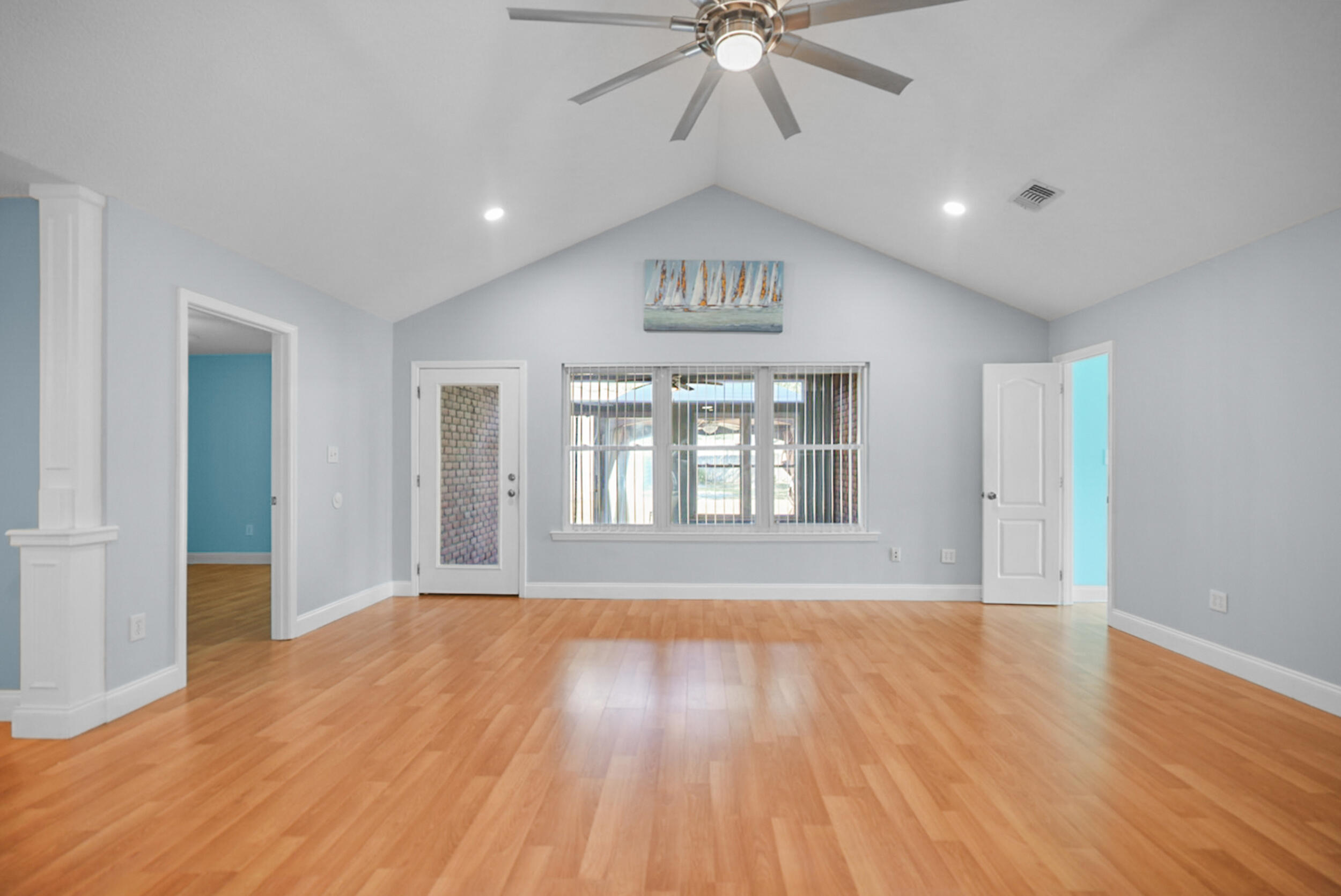 8600 Estrada Street Navarre, FL 32566 - Photo 20 of 63 a view of an empty room with wooden floor and a window