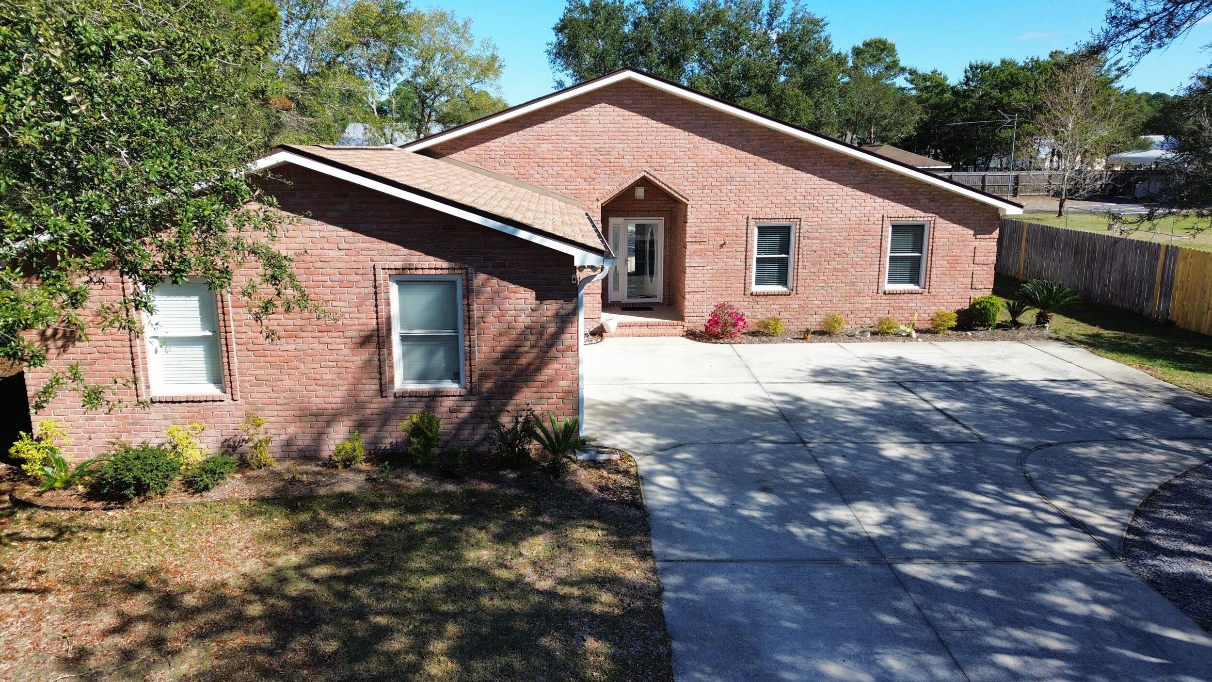 8600 Estrada Street Navarre, FL 32566 - Photo 2 of 63 a view of a house with a yard