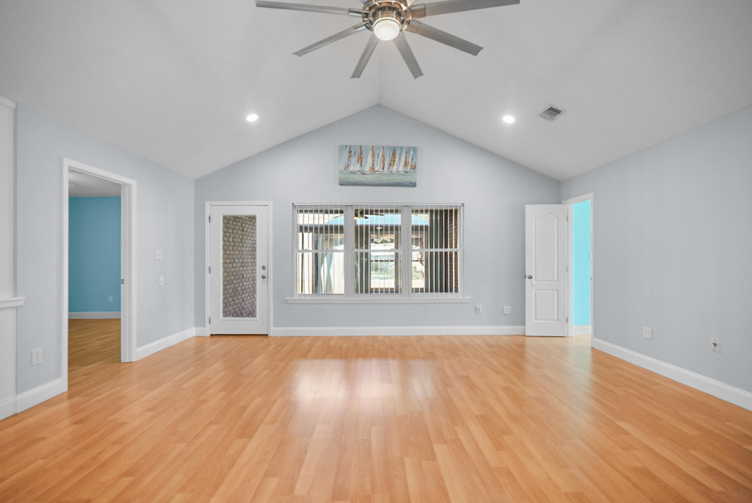 8600 Estrada Street Navarre, FL 32566 - Photo 21 of 63 a view of an empty room with a window and wooden floor