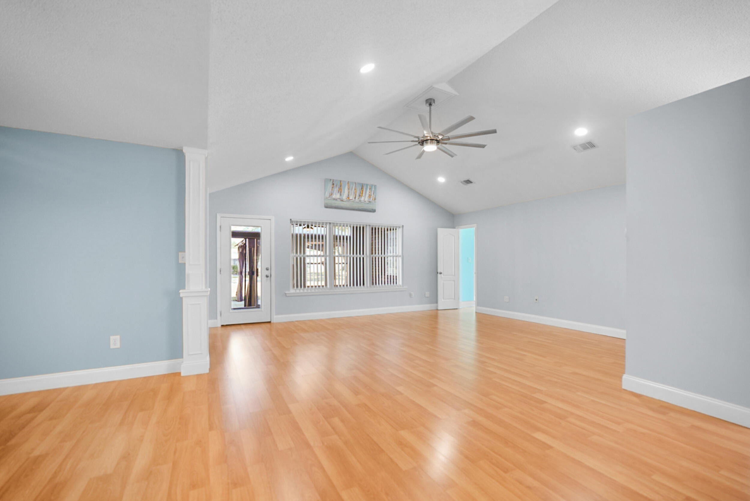 8600 Estrada Street Navarre, FL 32566 - Photo 22 of 63 wooden floor in an empty room with a window