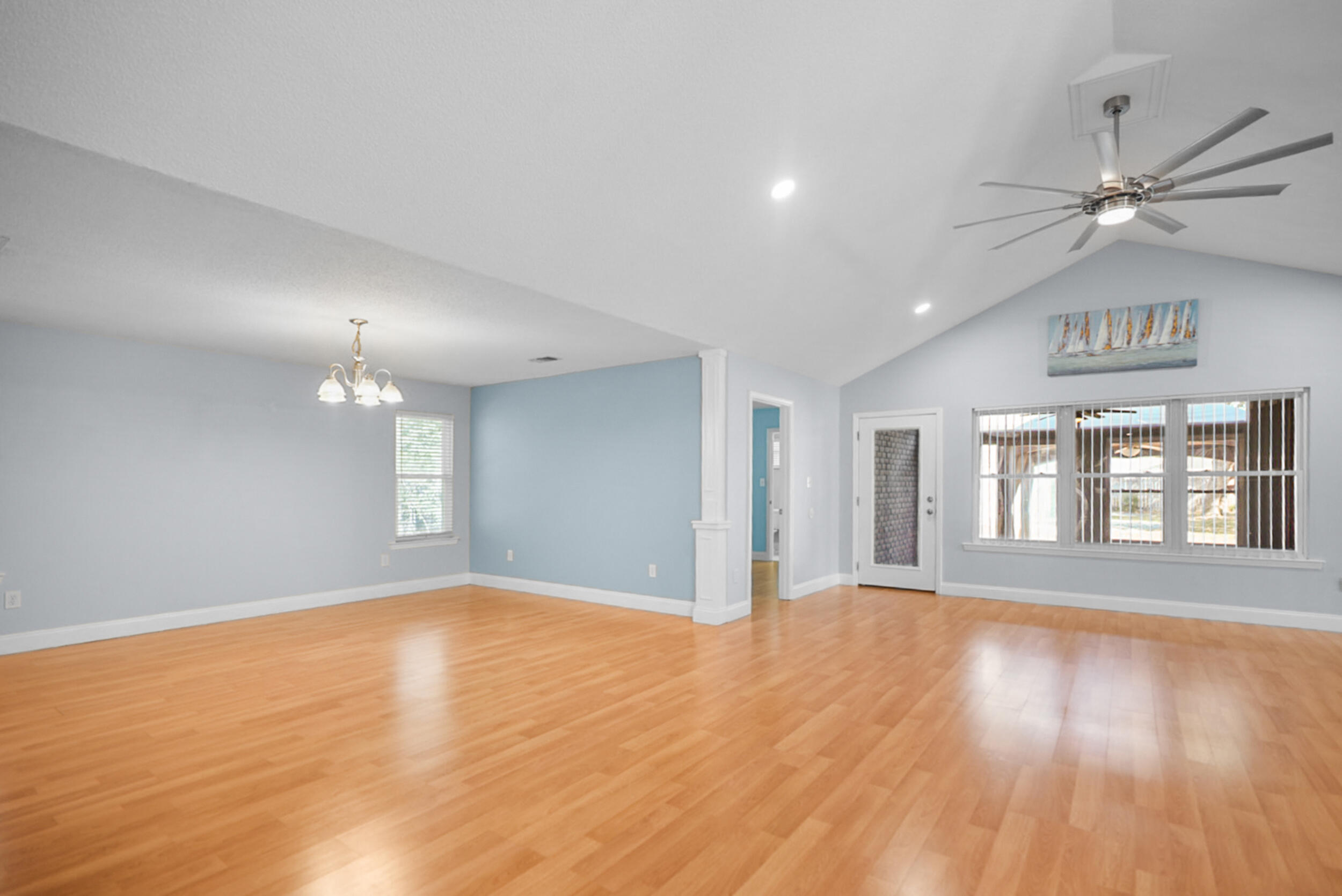 8600 Estrada Street Navarre, FL 32566 - Photo 23 of 63 a view of an empty room with wooden floor and a window