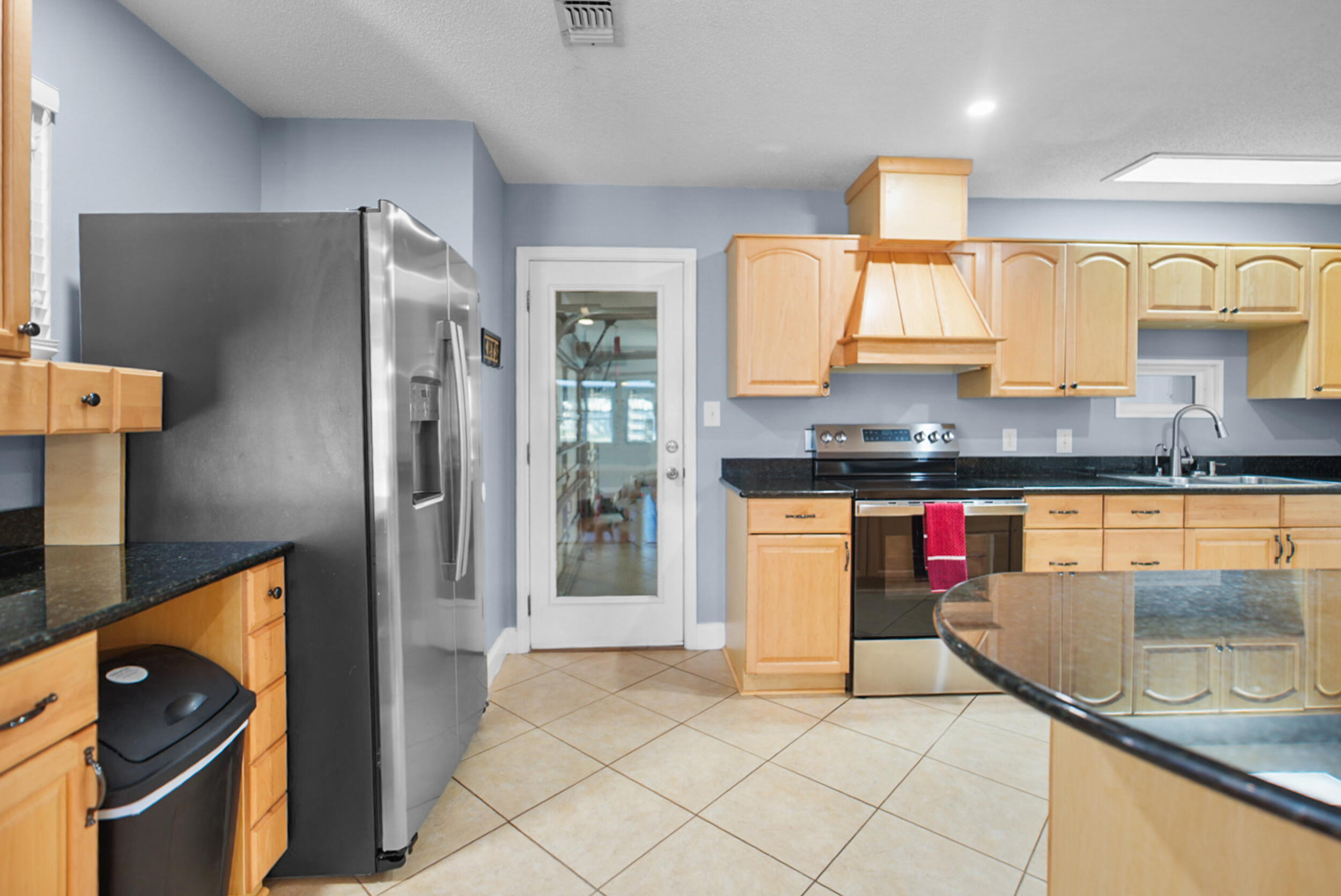 8600 Estrada Street Navarre, FL 32566 - Photo 29 of 63 a kitchen with stainless steel appliances granite countertop a refrigerator and a sink