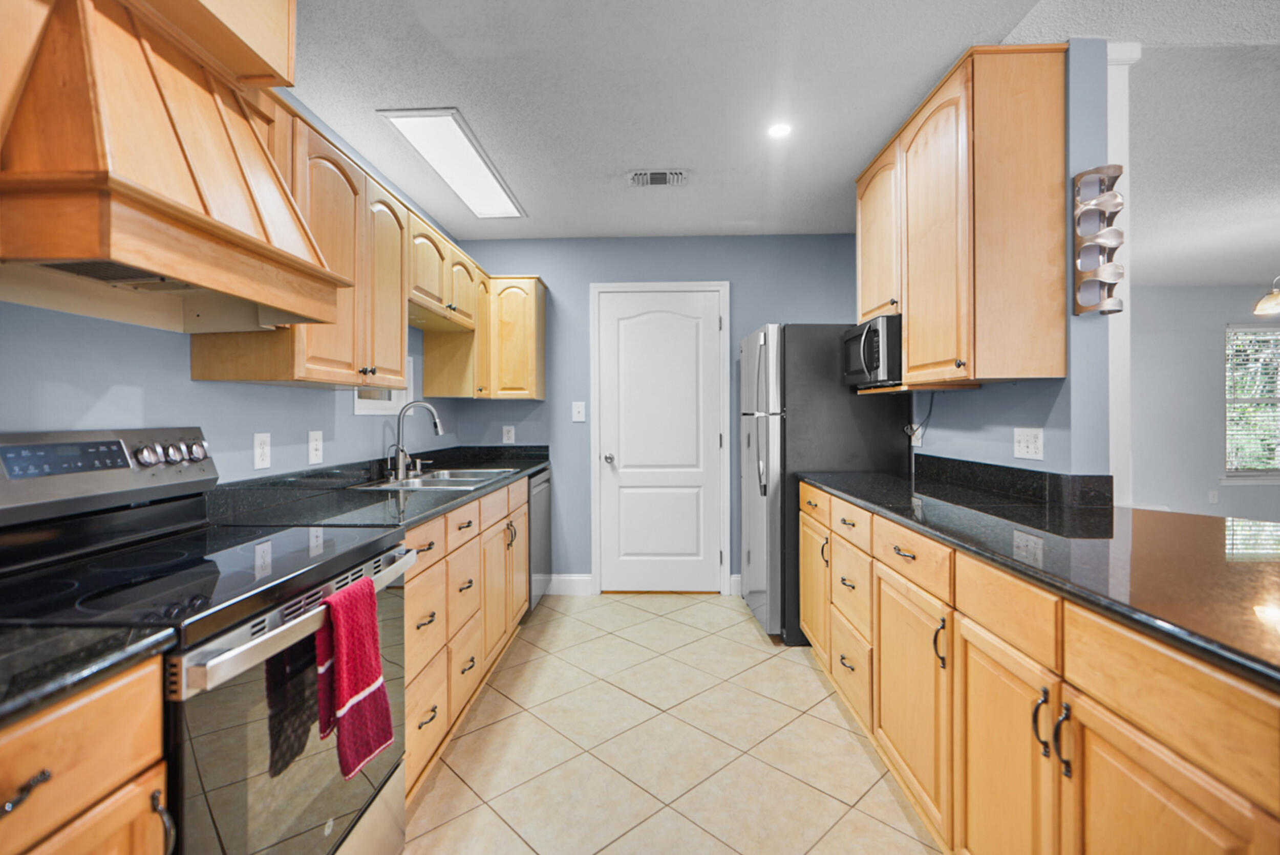 8600 Estrada Street Navarre, FL 32566 - Photo 30 of 63 a kitchen with stainless steel appliances granite countertop a stove a sink and a refrigerator