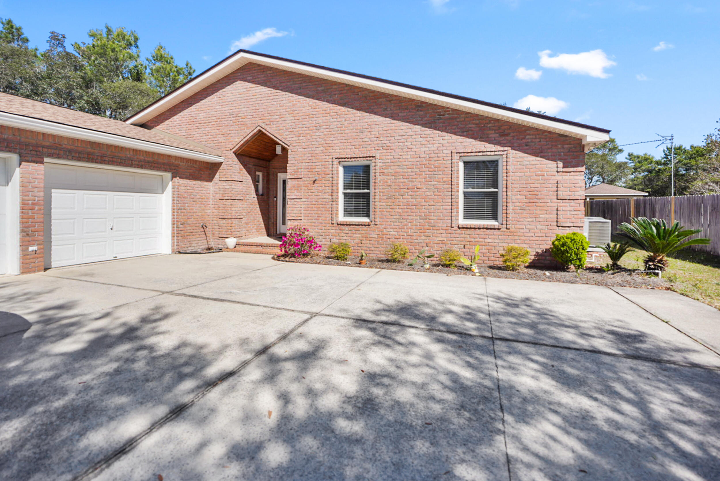 8600 Estrada Street Navarre, FL 32566 - Photo 3 of 63 a view of a house with backyard and sitting area