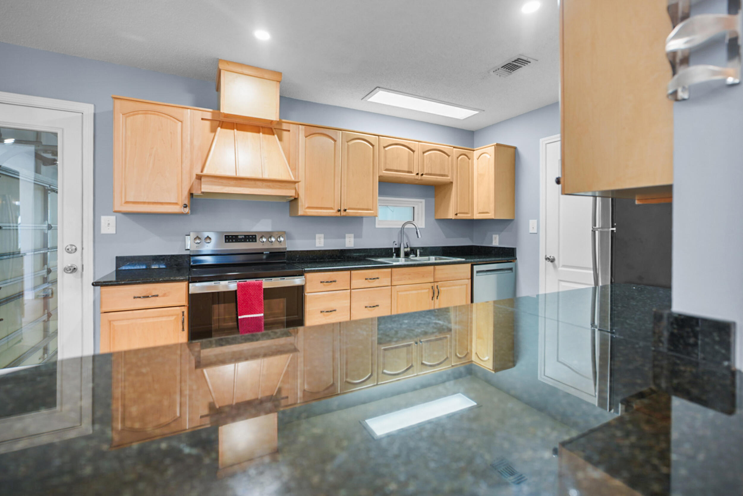 8600 Estrada Street Navarre, FL 32566 - Photo 32 of 63 a kitchen with stainless steel appliances granite countertop a stove a sink and a refrigerator