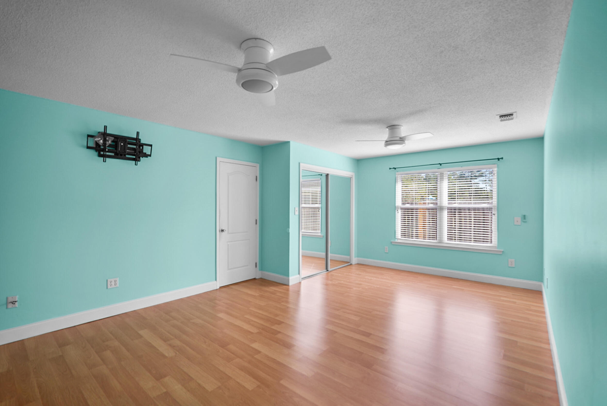 8600 Estrada Street Navarre, FL 32566 - Photo 35 of 63 a view of an empty room with a window and wooden floor