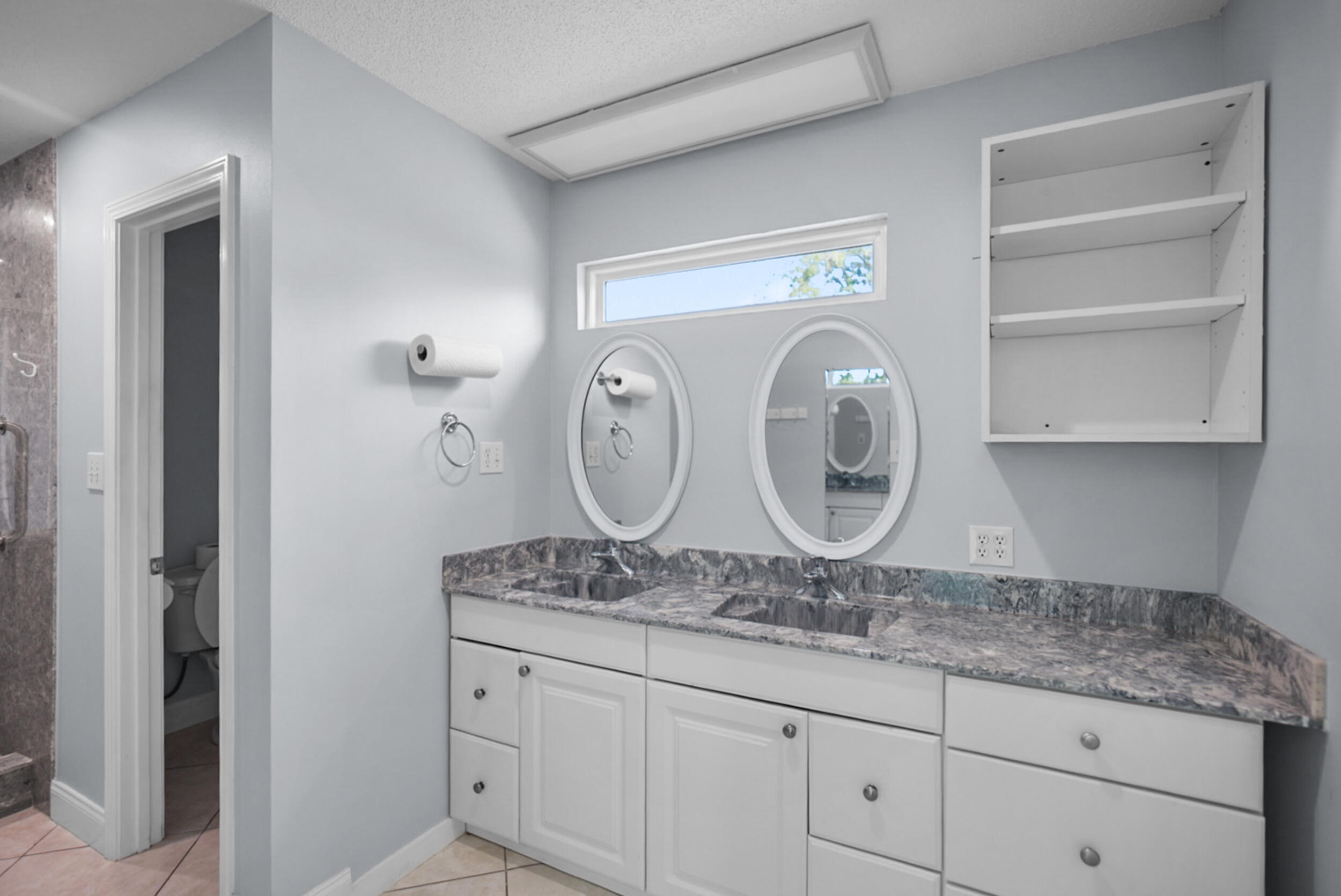 8600 Estrada Street Navarre, FL 32566 - Photo 37 of 63 a bathroom with a granite countertop sink and a mirror
