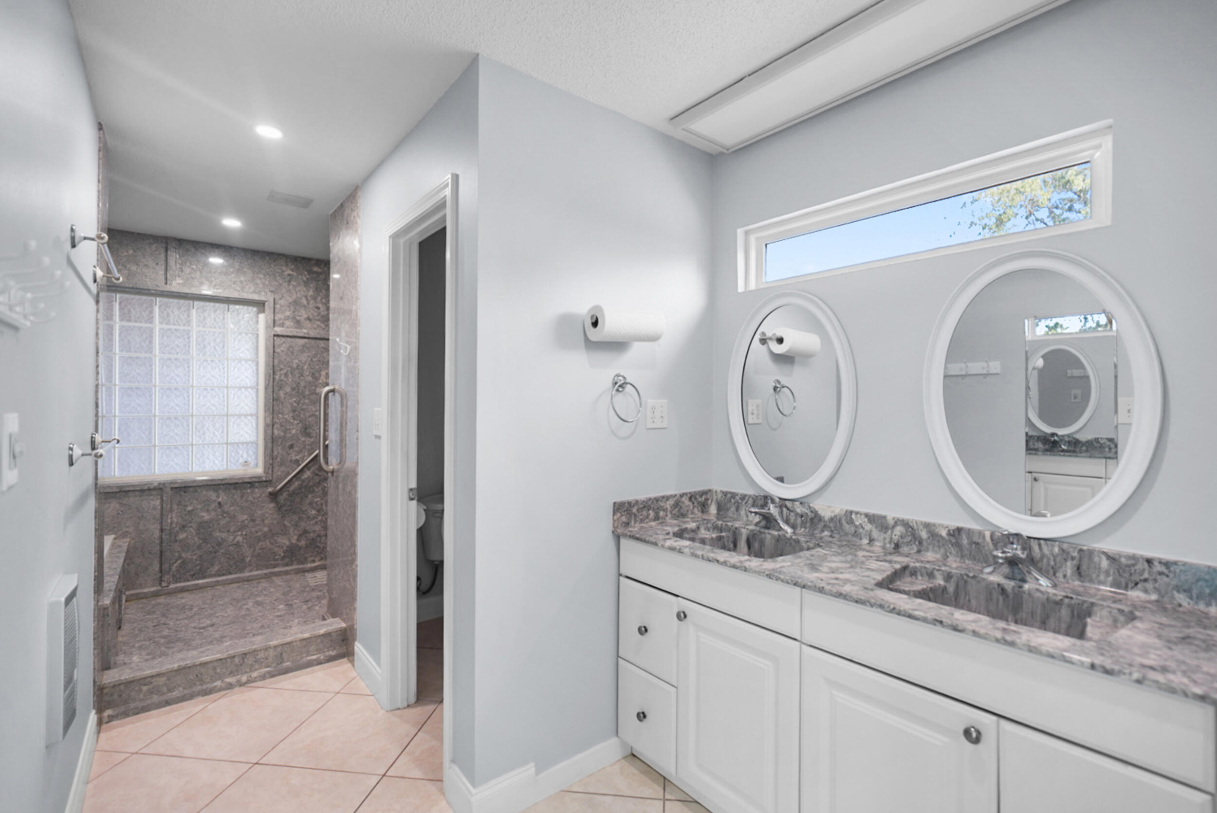 8600 Estrada Street Navarre, FL 32566 - Photo 38 of 63 a bathroom with a granite countertop sink and a mirror