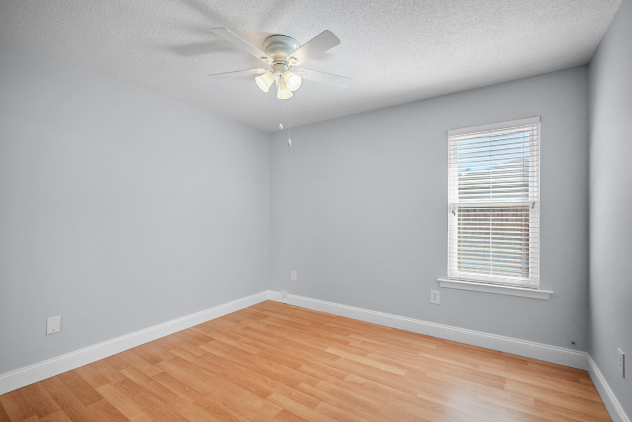8600 Estrada Street Navarre, FL 32566 - Photo 41 of 63 wooden floor in an empty room with a window