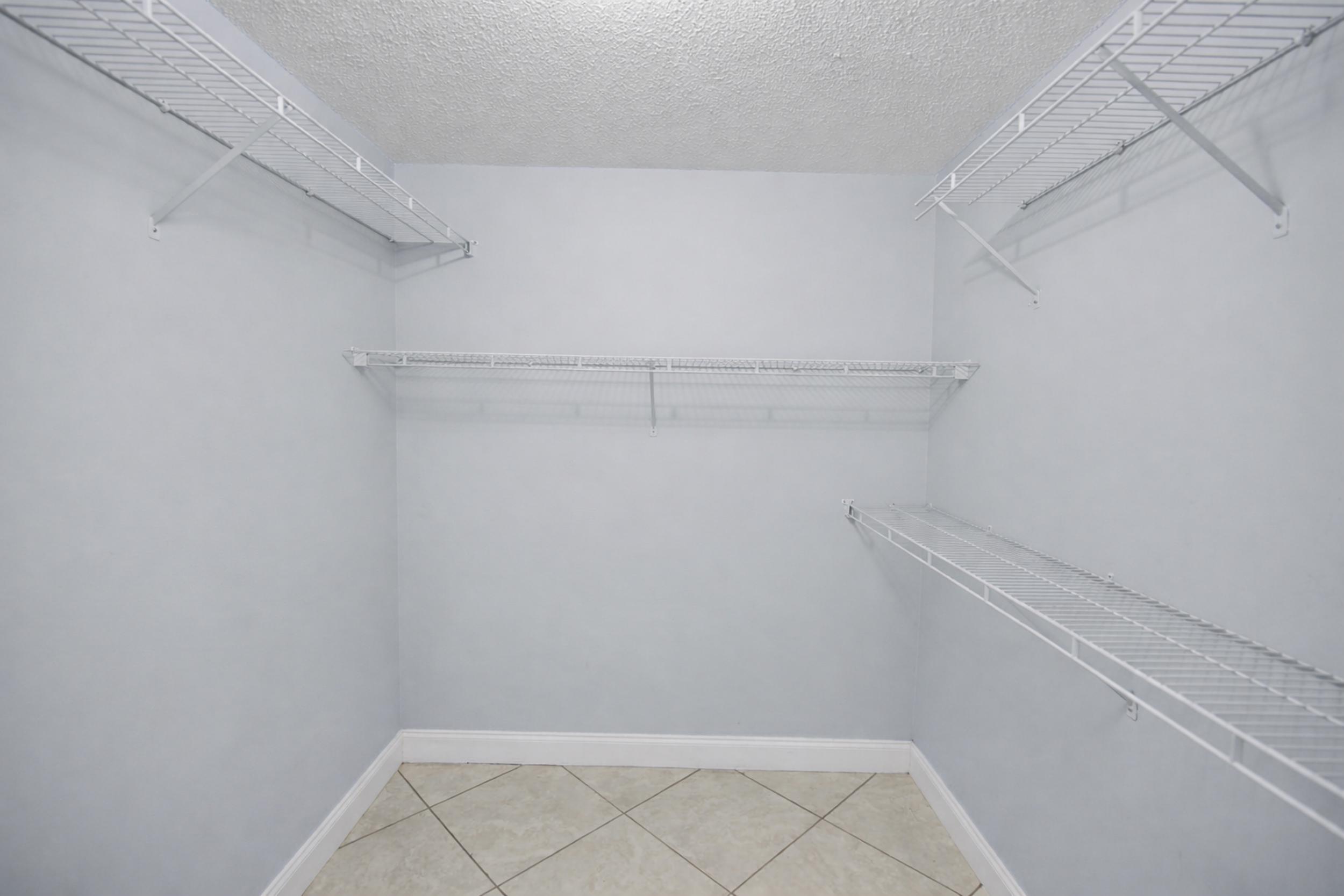 8600 Estrada Street Navarre, FL 32566 - Photo 46 of 63 a view of a room with racks on the wall
