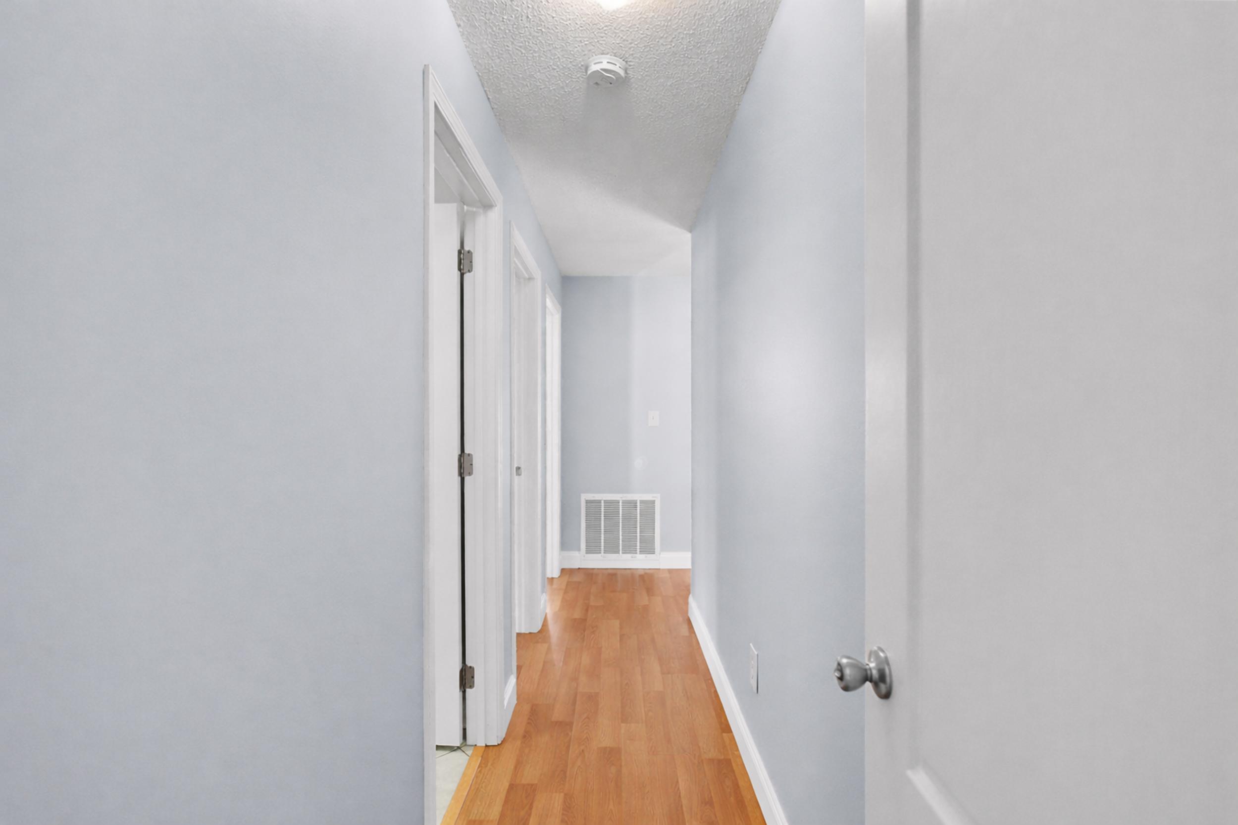 8600 Estrada Street Navarre, FL 32566 - Photo 47 of 63 a view of a hallway with wooden floor and entryway
