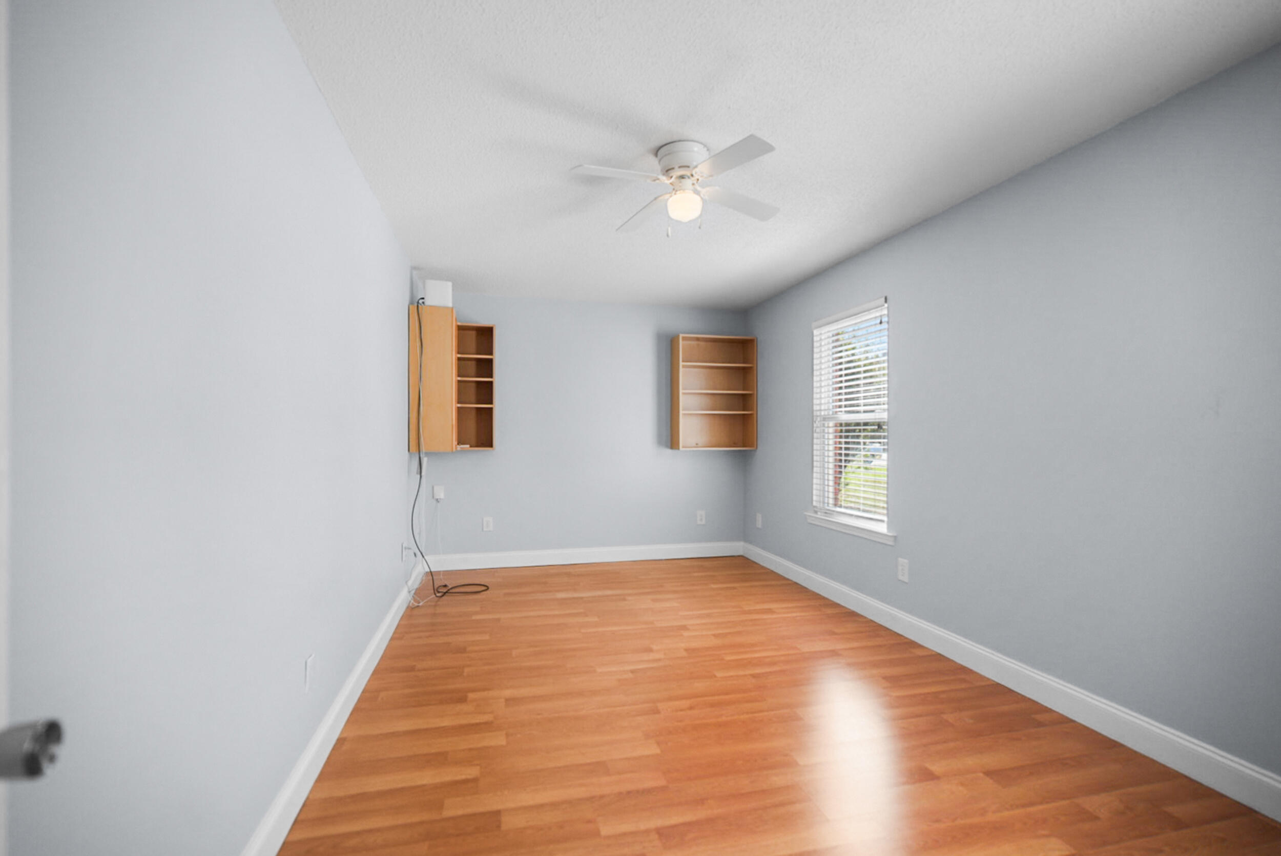8600 Estrada Street Navarre, FL 32566 - Photo 48 of 63 a view of an empty room with wooden floor and a window
