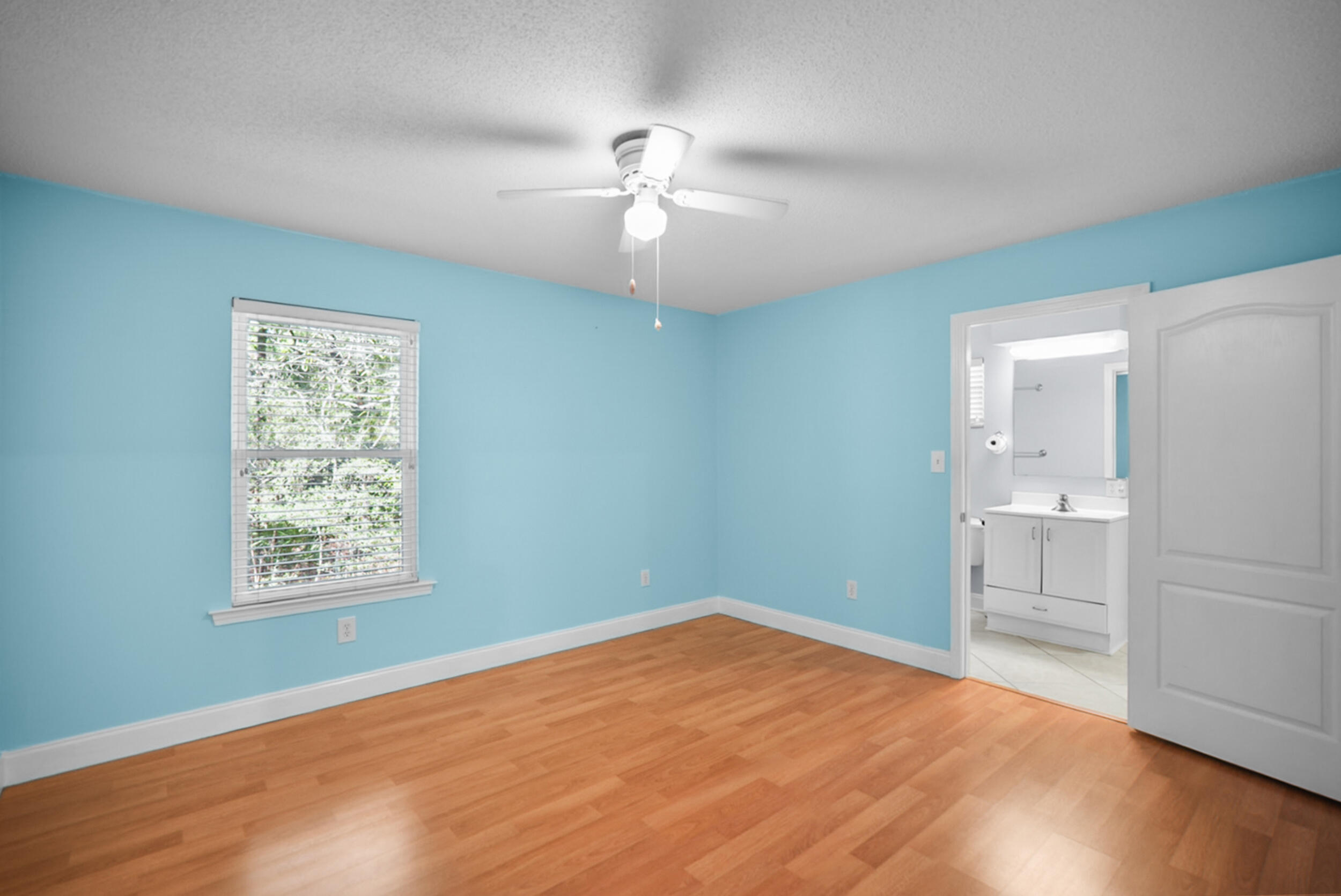 8600 Estrada Street Navarre, FL 32566 - Photo 49 of 63 a view of an empty room with a window and wooden floor