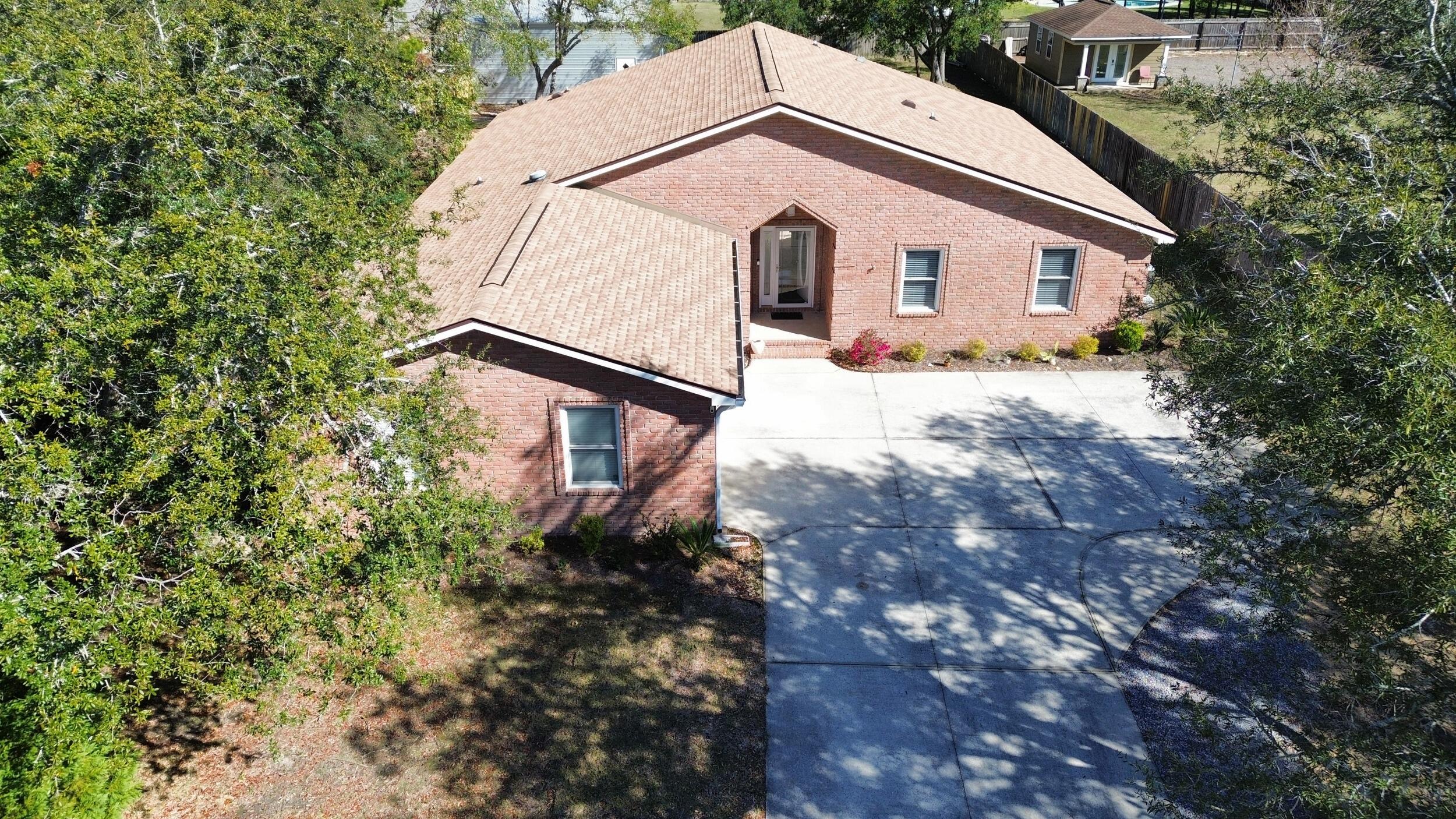 8600 Estrada Street Navarre, FL 32566 - Photo 5 of 63 a view of a house with a yard