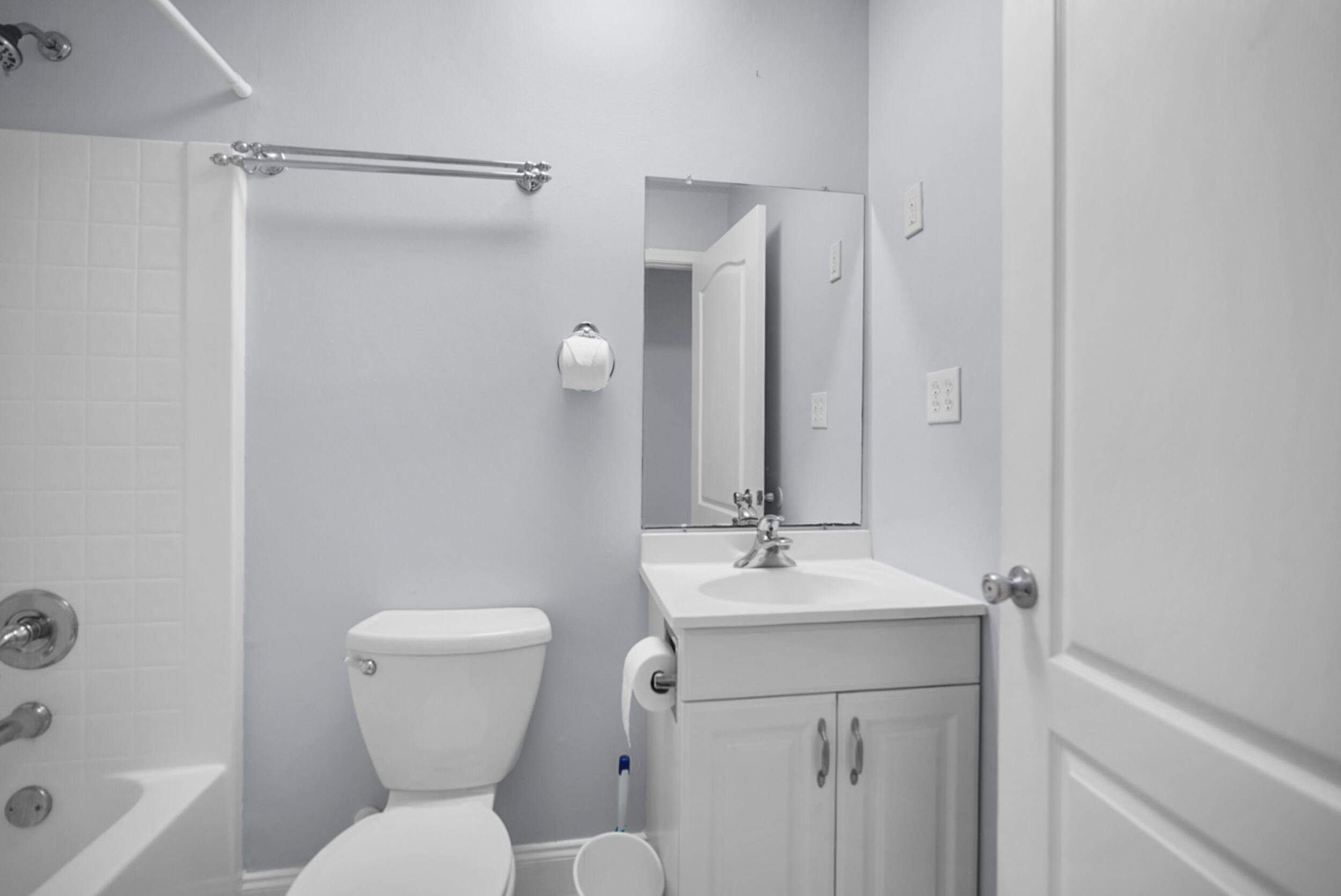8600 Estrada Street Navarre, FL 32566 - Photo 51 of 63 a bathroom with a toilet sink and mirror