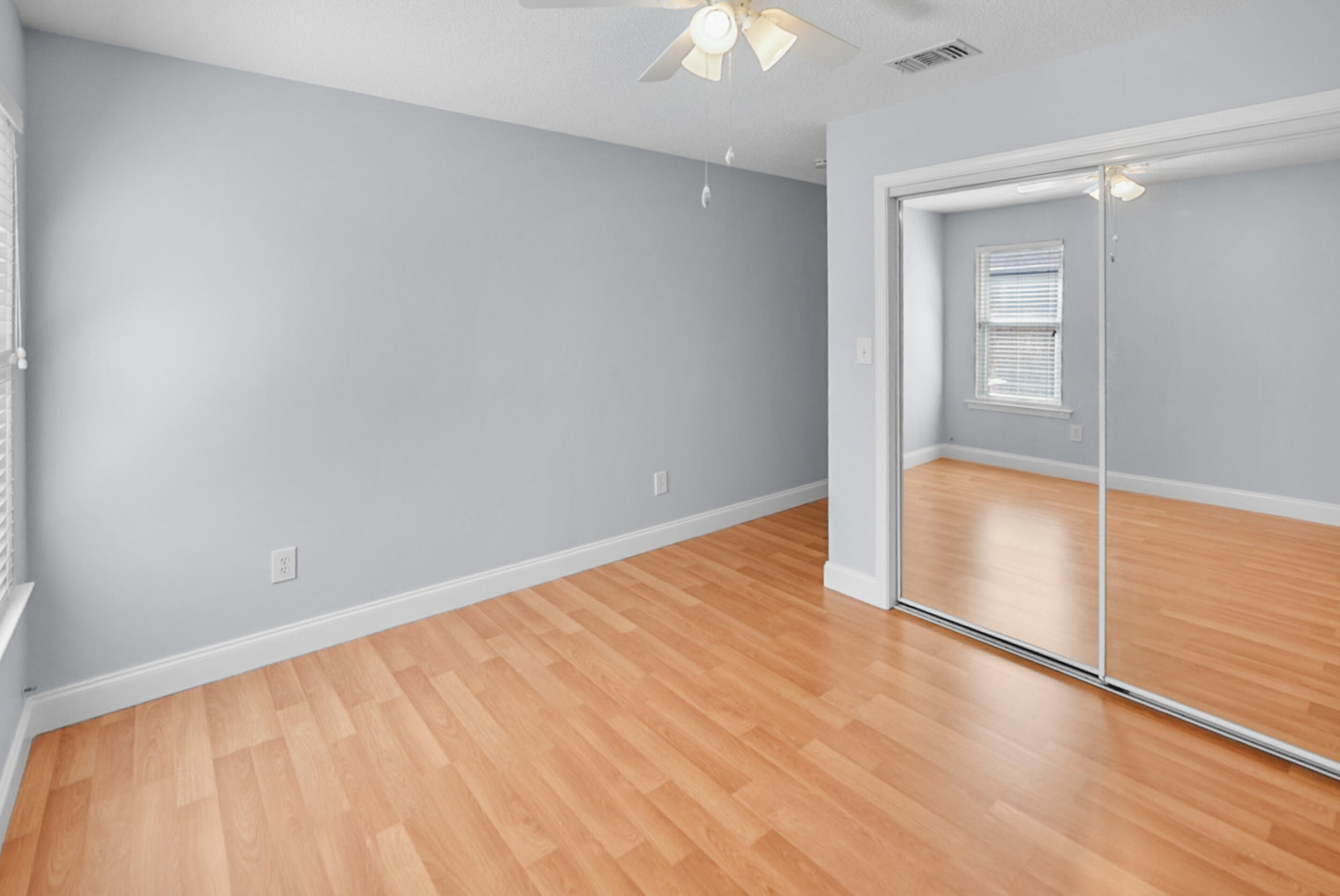 8600 Estrada Street Navarre, FL 32566 - Photo 54 of 63 wooden floor in an empty room with a window