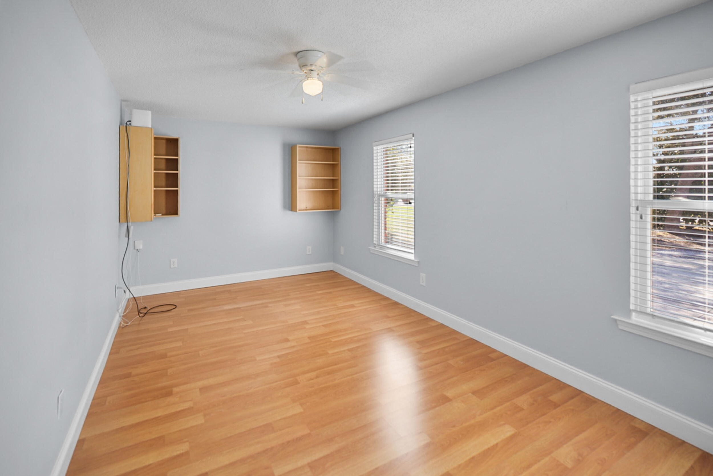 8600 Estrada Street Navarre, FL 32566 - Photo 55 of 63 a view of an empty room with wooden floor and a window