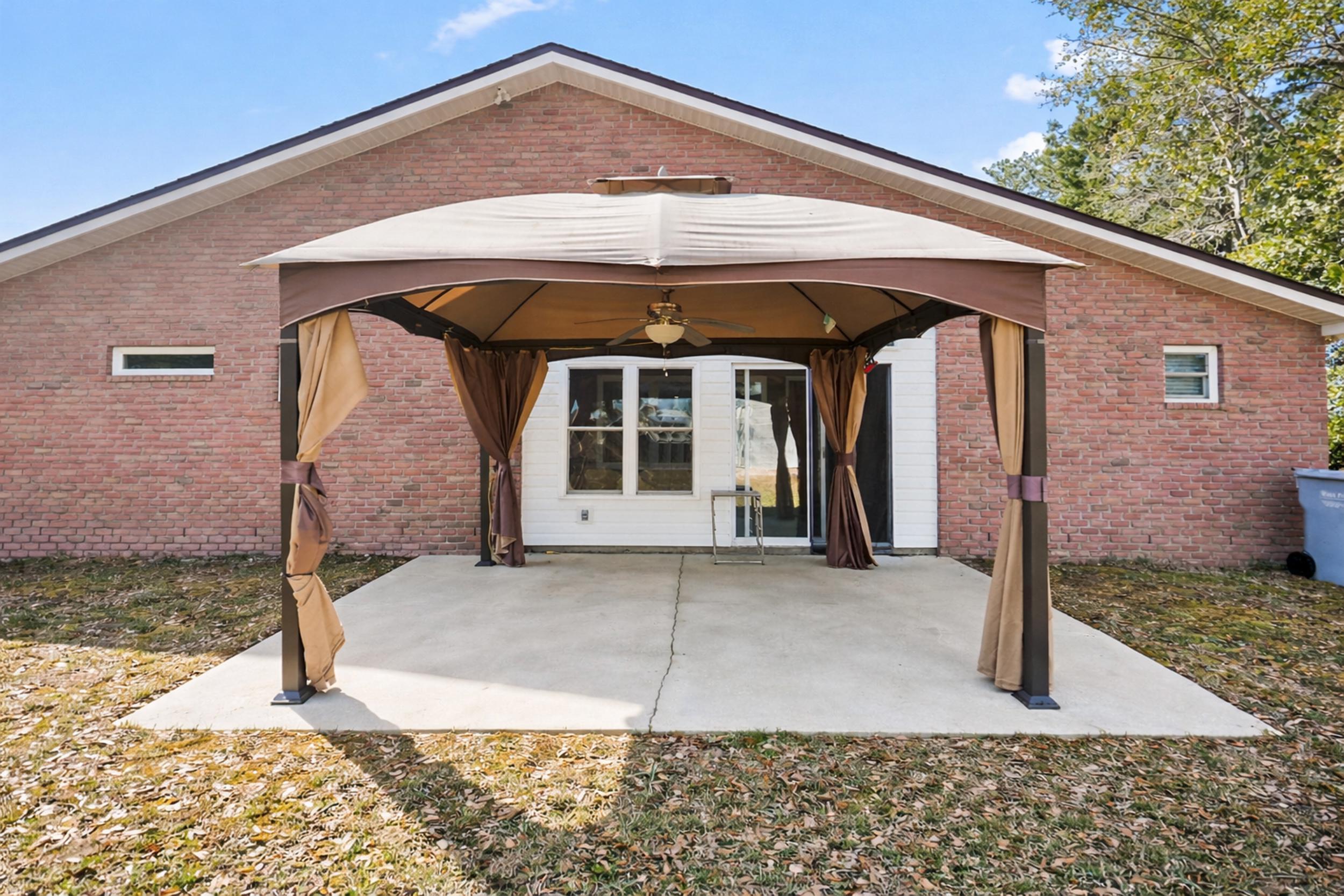 8600 Estrada Street Navarre, FL 32566 - Photo 58 of 63 a front view of a house with parking