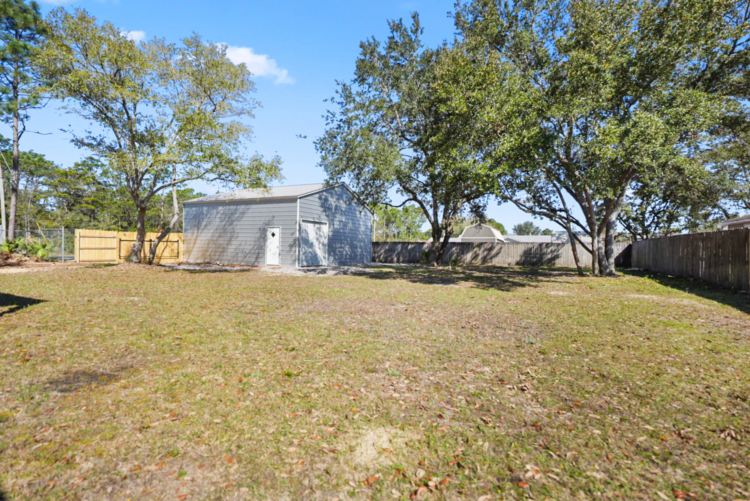 8600 Estrada Street Navarre, FL 32566 - Photo 59 of 63 a view of empty room with tree s