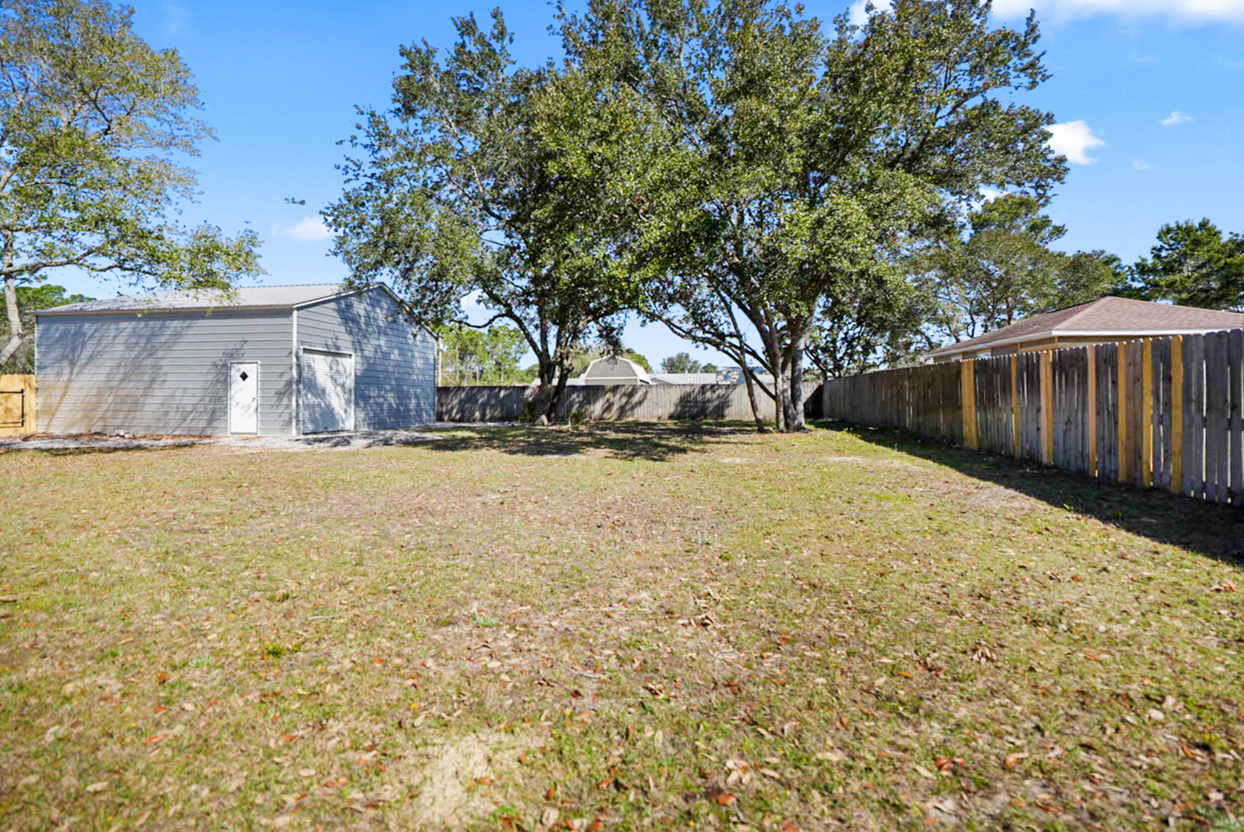 8600 Estrada Street Navarre, FL 32566 - Photo 60 of 63 a view of large yard with large trees
