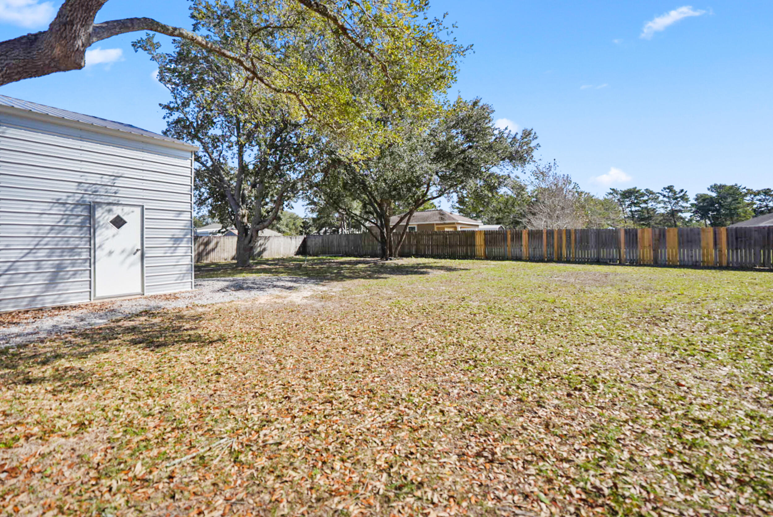 8600 Estrada Street Navarre, FL 32566 - Photo 61 of 63 a view of a yard with a house