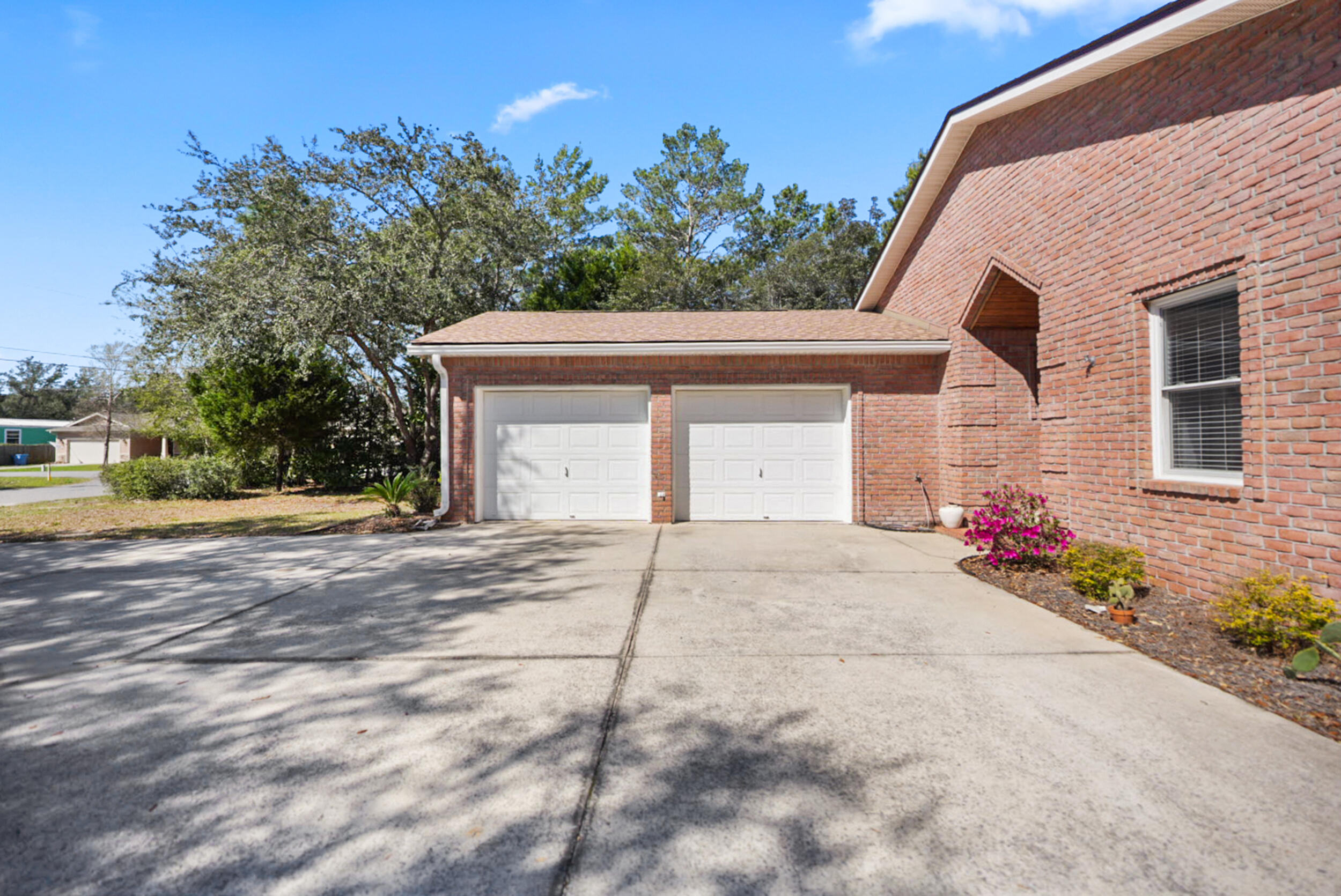 8600 Estrada Street Navarre, FL 32566 - Photo 7 of 63 a front view of a house with a yard and garage
