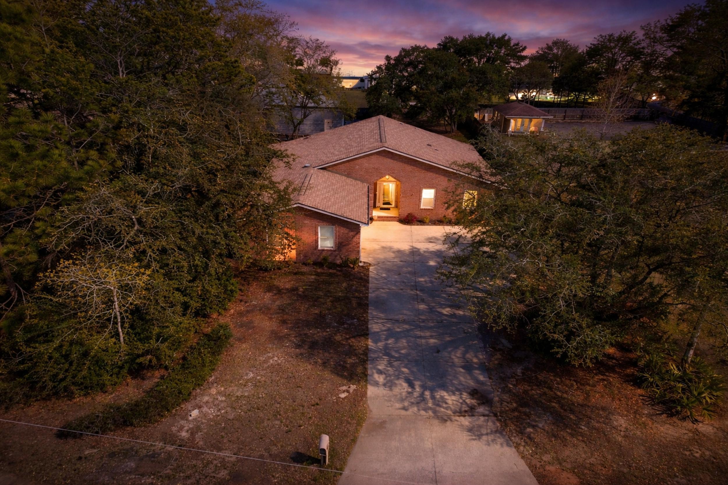 8600 Estrada Street Navarre, FL 32566 - Photo 8 of 63 a view of a house with a yard