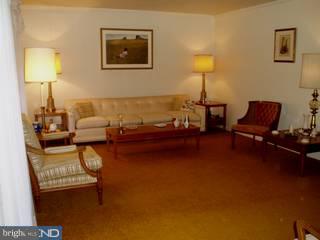 917 Penn Valley Road Media, PA 19063 - Photo 2 of 6 a living room with furniture and a lamp