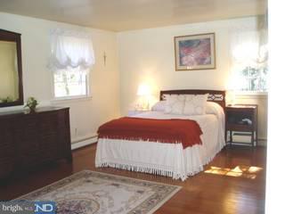 917 Penn Valley Road Media, PA 19063 - Photo 5 of 6 a bedroom with a bed and a couch