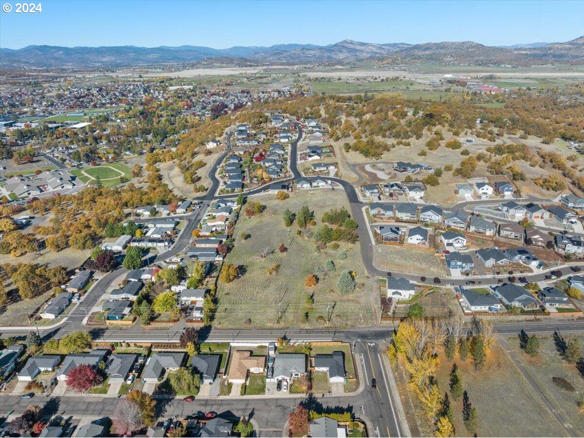 653 Stevens Road Eagle Point, OR 97524 - Photo 10 of 12 an aerial view of residential houses with outdoor space