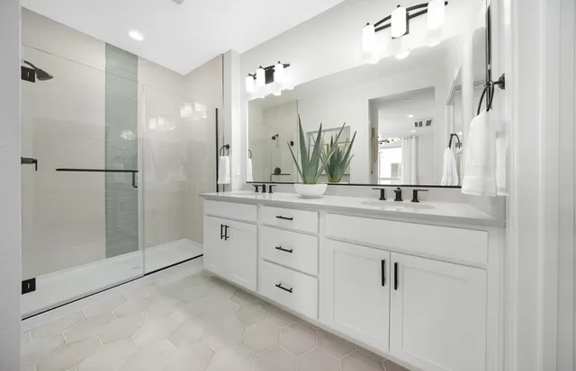 a bathroom with a double vanity sink mirror and double