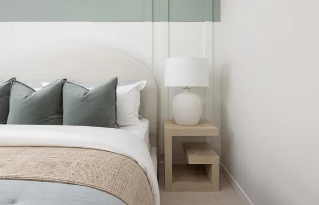 a bedroom with a bed and lamp