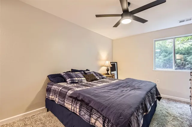 a bedroom with a bed and window