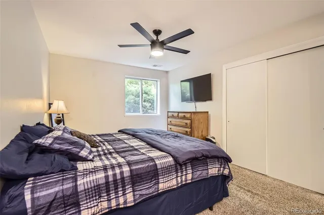 a bedroom with a large bed and a window