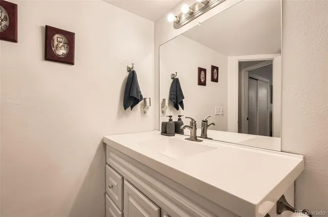 a bathroom with a sink vanity and a mirror