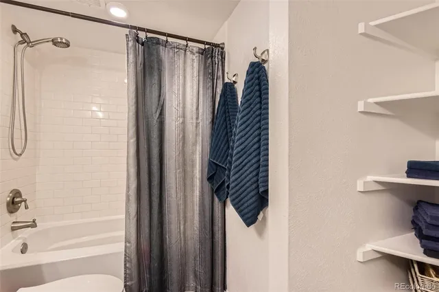 a bathroom with a shower and a tub