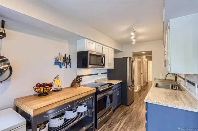 a kitchen with stainless steel appliances a stove a sink dishwasher and a refrigerator