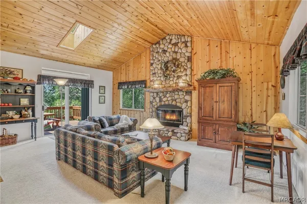 a living room with furniture a fireplace and a table