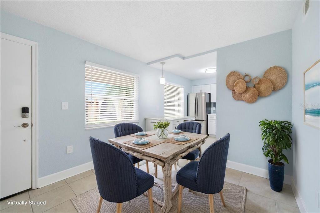 17035 Gulf Boulevard, Unit 118 North Redington Beach, FL 33708 - Photo 14 of 44 a view of a dining room with furniture and window