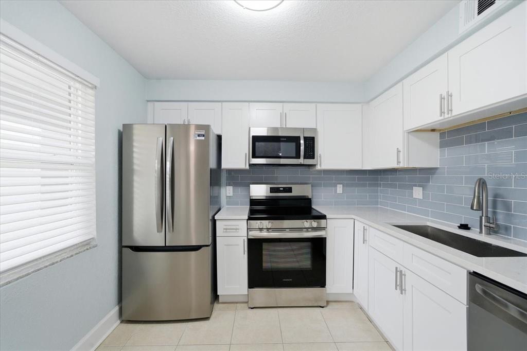 17035 Gulf Boulevard, Unit 118 North Redington Beach, FL 33708 - Photo 18 of 44 a kitchen with a refrigerator sink and stove