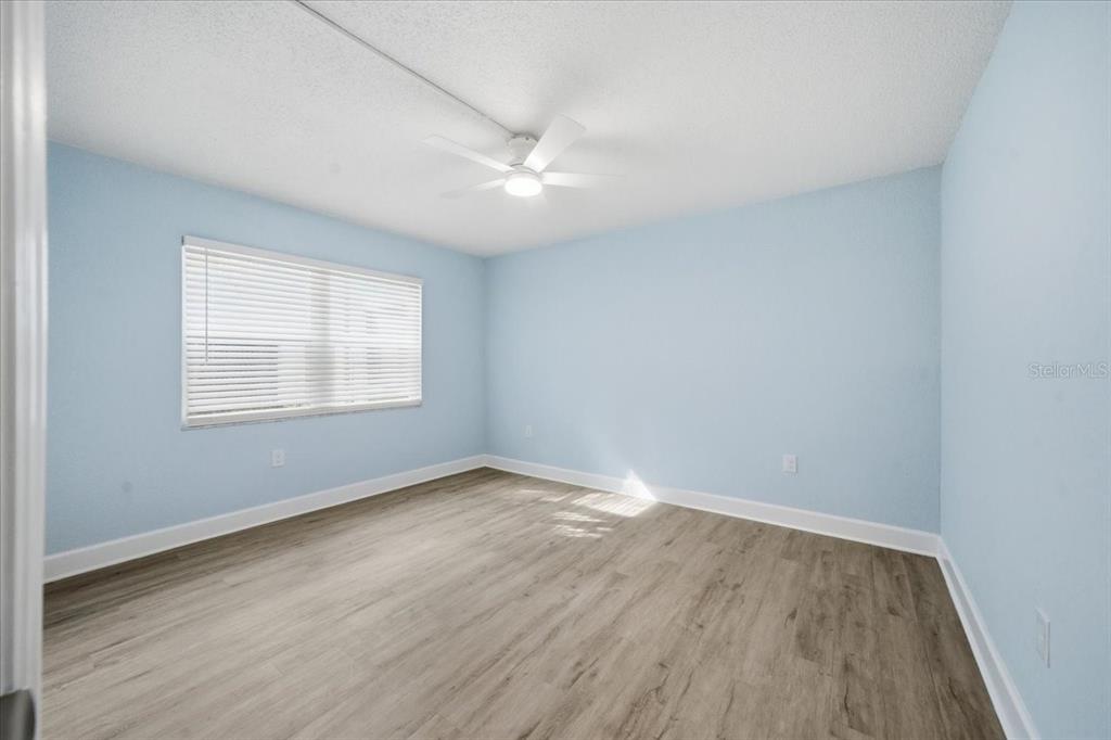 17035 Gulf Boulevard, Unit 118 North Redington Beach, FL 33708 - Photo 29 of 44 an empty room with wooden floor and windows