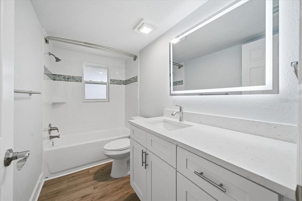 17035 Gulf Boulevard, Unit 118 North Redington Beach, FL 33708 - Photo 31 of 44 a bathroom with a sink a toilet and shower