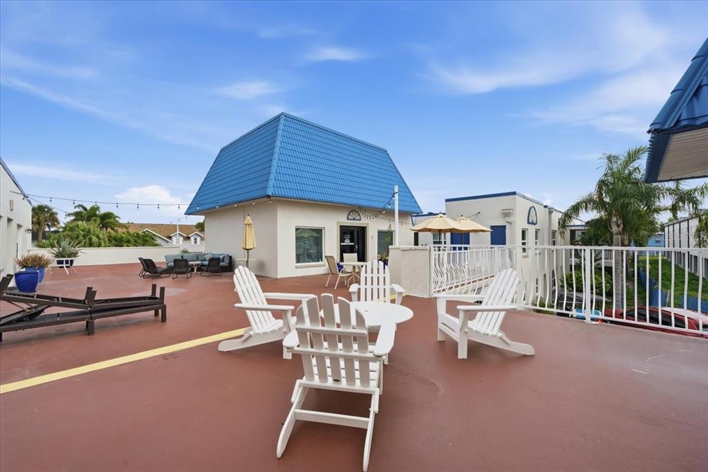 17035 Gulf Boulevard, Unit 118 North Redington Beach, FL 33708 - Photo 38 of 44 a view of a patio with a table and chairs