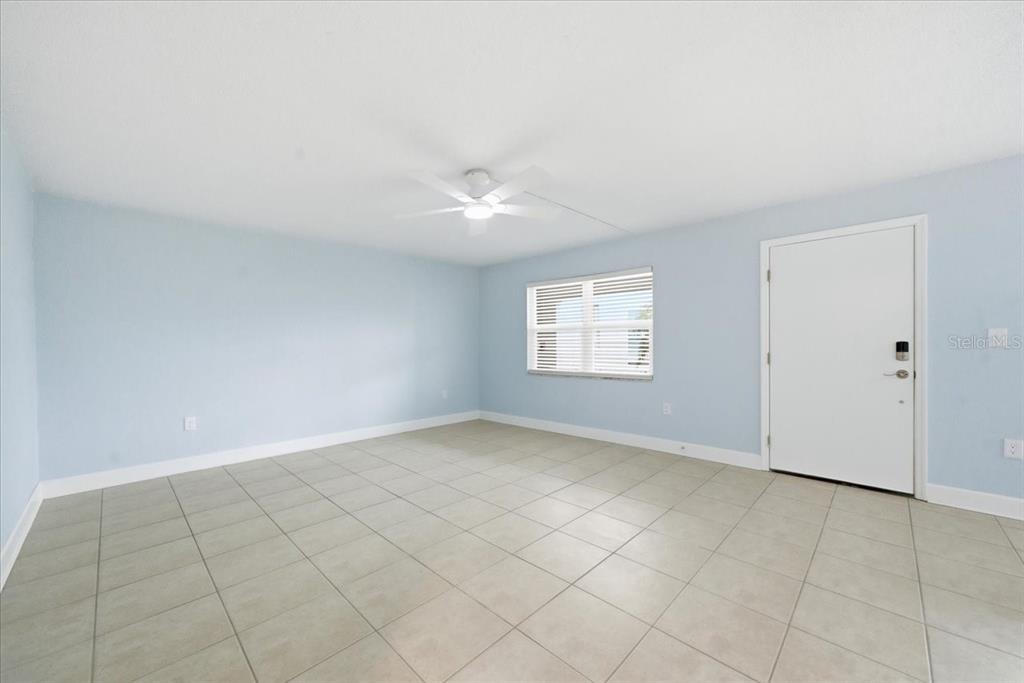 17035 Gulf Boulevard, Unit 118 North Redington Beach, FL 33708 - Photo 6 of 44 an empty room with windows and white walls